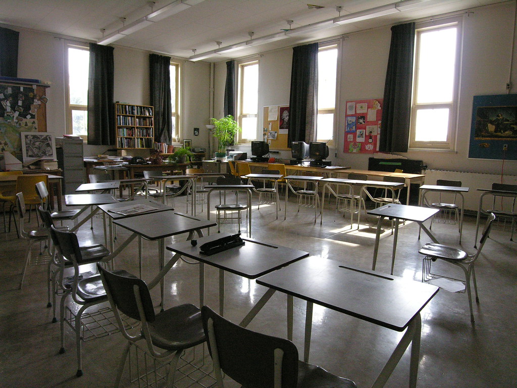 Classroom. Attribution: <p style="font-size: 0.9rem;font-style: italic;"><a href="https://www.flickr.com/photos/52678969@N05/5604587723">"classroom 2nd fl"</a><span>by <a href="https://www.flickr.com/photos/52678969@N05">cayoup</a></span> is licensed under <a href="https://creativecommons.org/licenses/by-nc-sa/2.0/?ref=ccsearch&atype=html" style="margin-right: 5px;">CC BY-NC-SA 2.0</a><a href="https://creativecommons.org/licenses/by-nc-sa/2.0/?ref=ccsearch&atype=html" target="_blank" rel="noopener noreferrer" style="display: inline-block;white-space: none;opacity: .7;margin-top: 2px;margin-left: 3px;height: 22px !important;"><img style="height: inherit;margin-right: 3px;display: inline-block;" src="https://search.creativecommons.org/static/img/cc_icon.svg" /><img style="height: inherit;margin-right: 3px;display: inline-block;" src="https://search.creativecommons.org/static/img/cc-by_icon.svg" /><img style="height: inherit;margin-right: 3px;display: inline-block;" src="https://search.creativecommons.org/static/img/cc-nc_icon.svg" /><img style="height: inherit;margin-right: 3px;display: inline-block;" src="https://search.creativecommons.org/static/img/cc-sa_icon.svg" /></a></p>