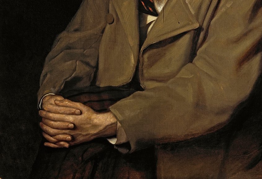 Russian writer, hands folded.